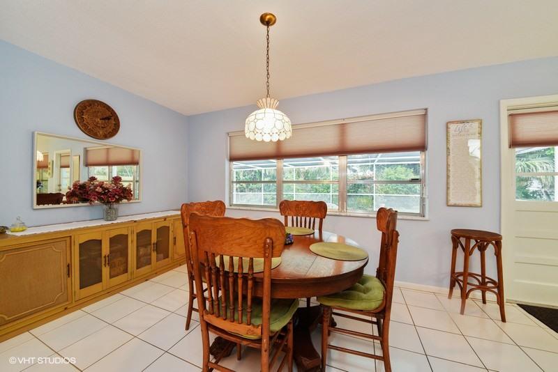 438 Dover Road Tequesta, FL 33469 - Photo 4 of 10 a dining room filled chandelier and wooden floor