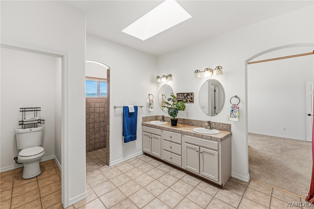 9332 Branded Road Kingman, AZ 86401 - Photo 20 of 44 a spacious bathroom with a double vanity sink toilet and shower