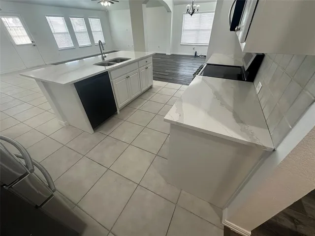 a kitchen with stainless steel appliances granite countertop a sink and a stove