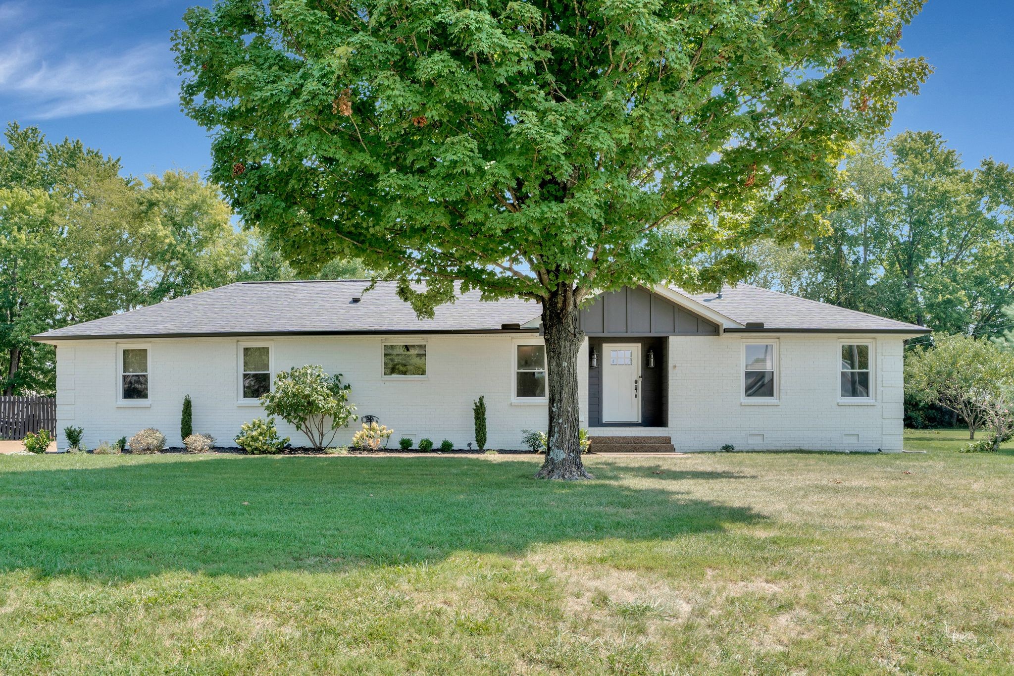 a front view of house with yard and green space