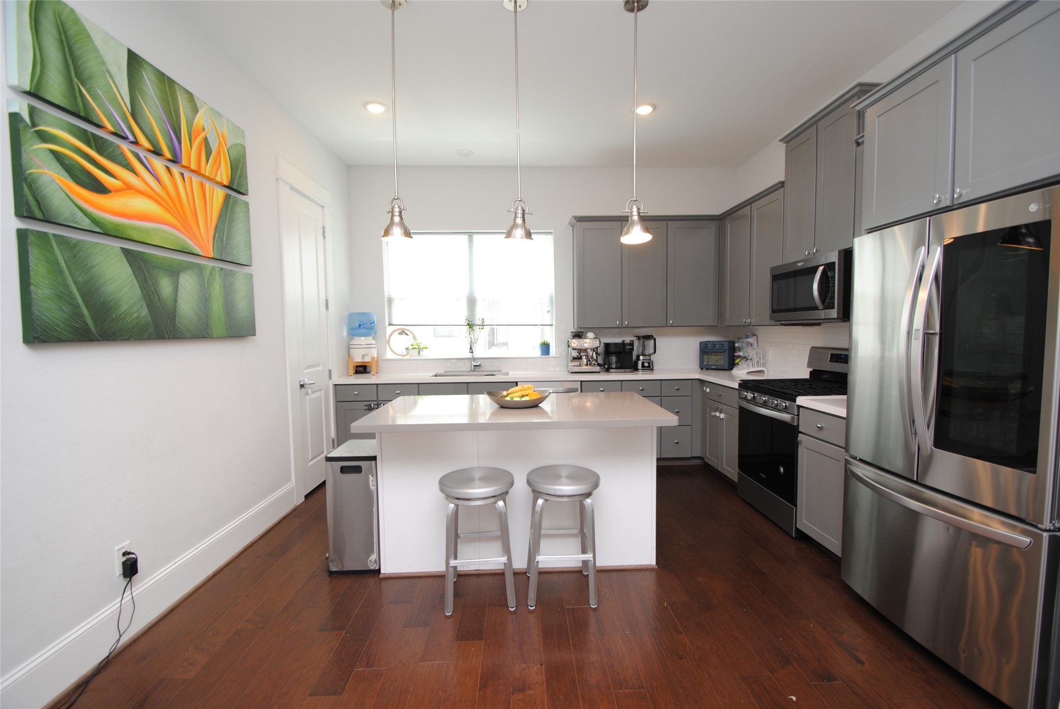 1262 North Post Oak Road, Unit B Houston, TX 77055 - Photo 12 of 44 a kitchen with stainless steel appliances a stove a sink a microwave a refrigerator and cabinets