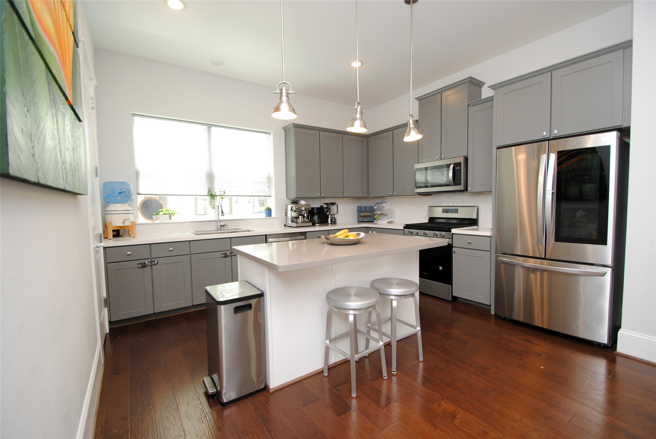 1262 North Post Oak Road, Unit B Houston, TX 77055 - Photo 13 of 44 a kitchen with a refrigerator a sink and a stove top oven