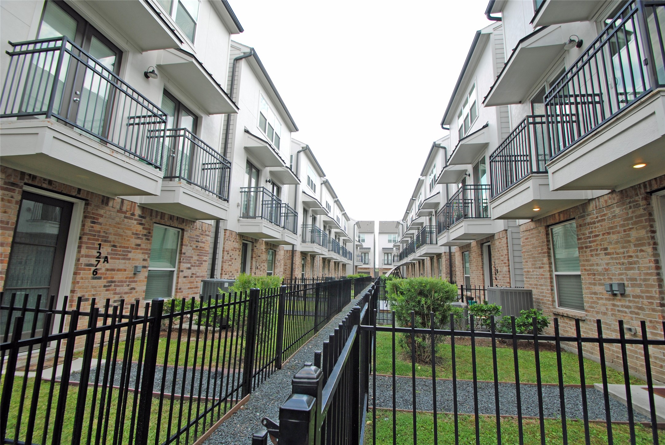 1262 North Post Oak Road, Unit B Houston, TX 77055 - Photo 2 of 44 a view of a brick building from a balcony