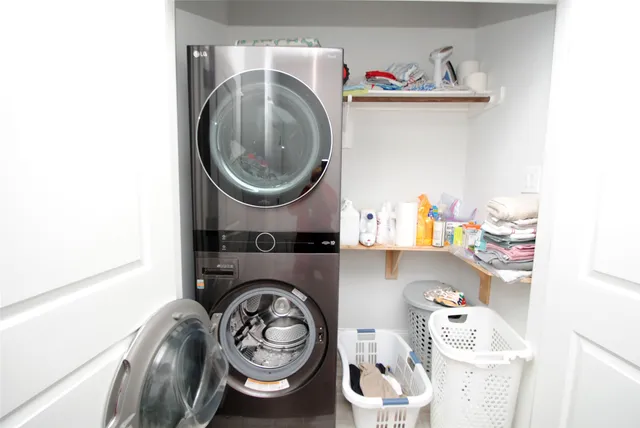 a utility room with sink dryer and washer