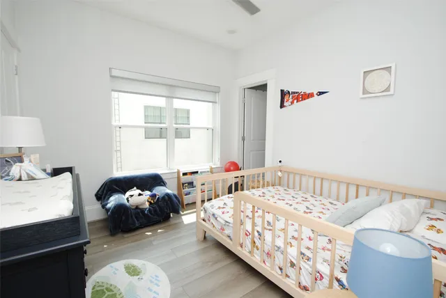 a bedroom with furniture and a window