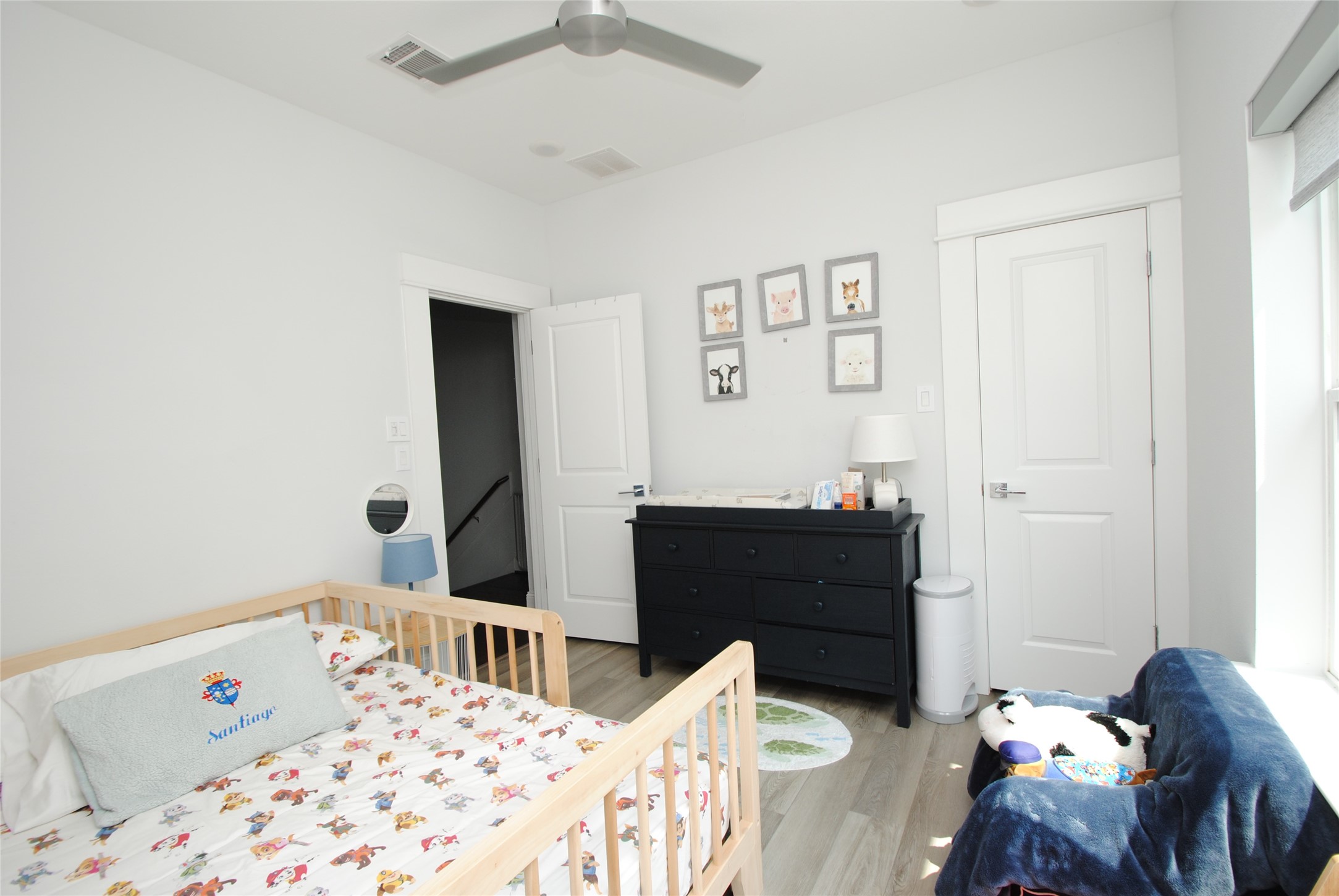 1262 North Post Oak Road, Unit B Houston, TX 77055 - Photo 29 of 44 a bedroom with a bed and wooden floor