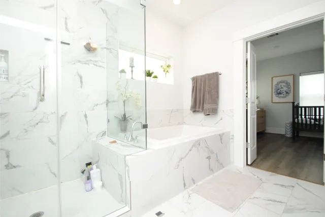a bathroom with a tub sink and mirror