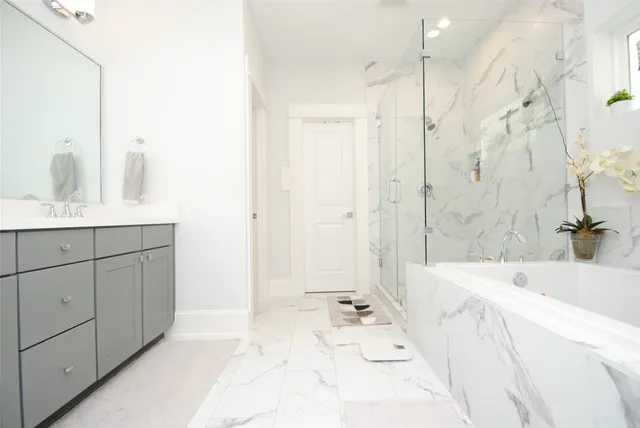 a bathroom with a bathtub sink and mirror