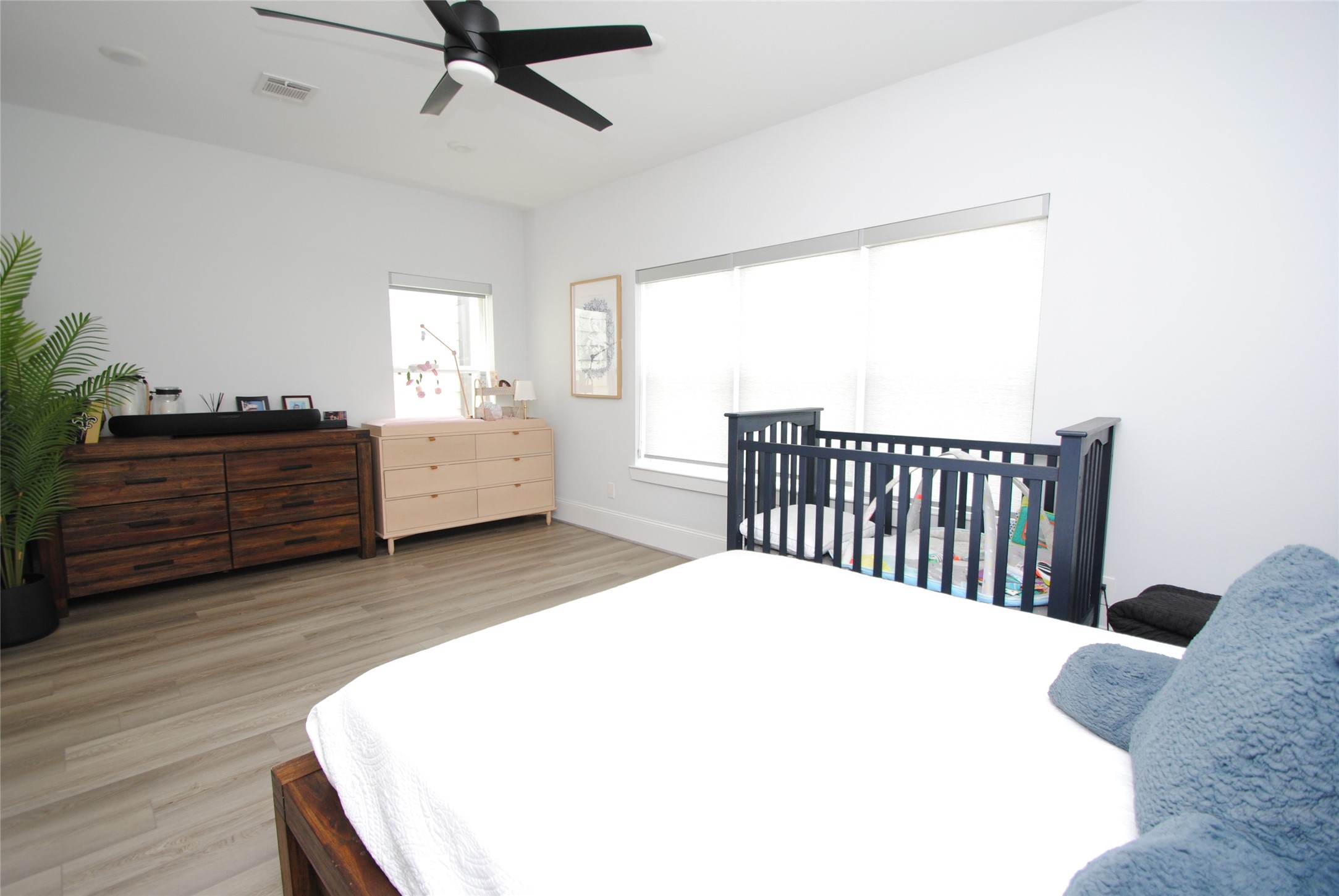 1262 North Post Oak Road, Unit B Houston, TX 77055 - Photo 40 of 44 a bedroom with a bed and dresser with wooden floor