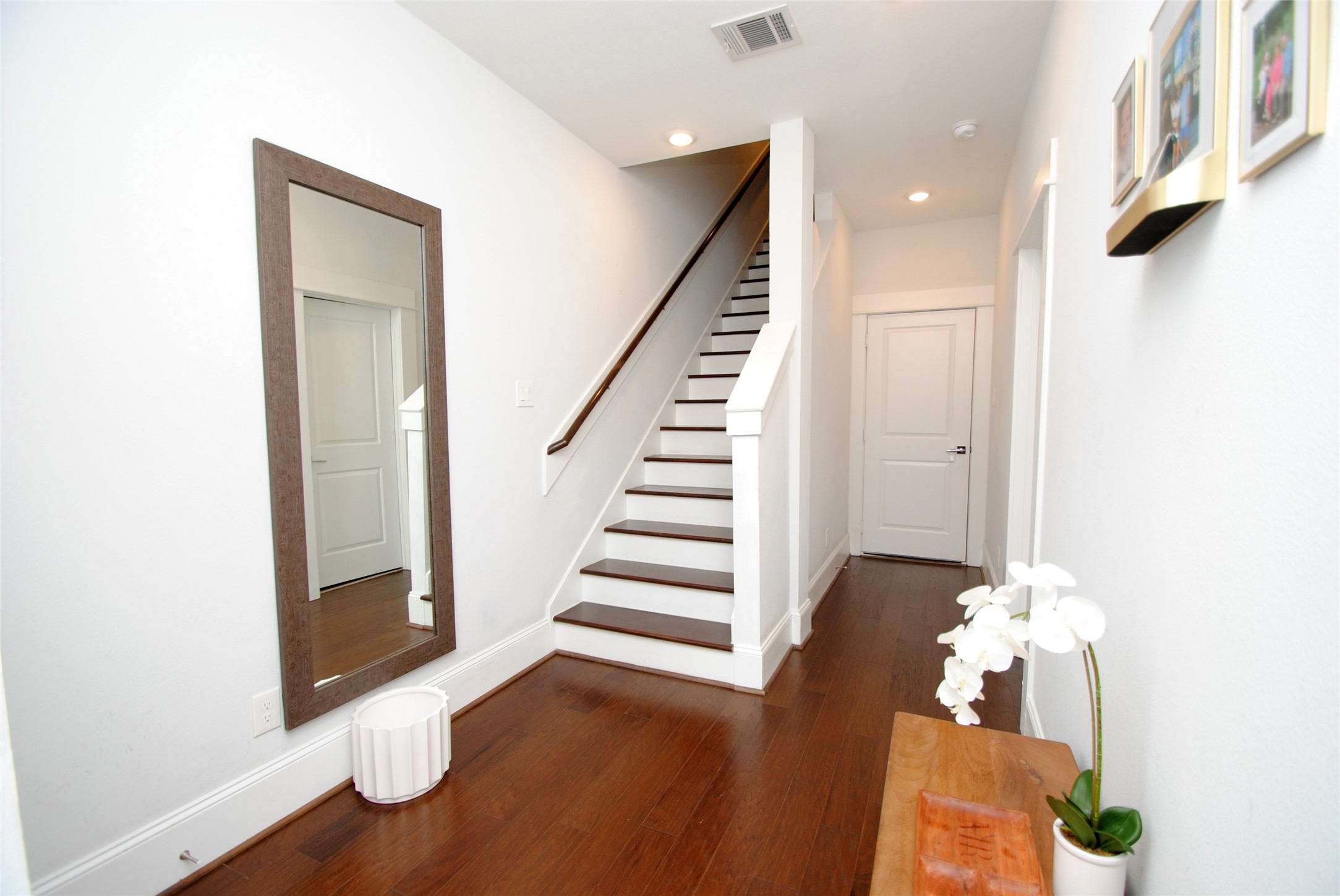 1262 North Post Oak Road, Unit B Houston, TX 77055 - Photo 4 of 44 a view of a hallway with entryway wooden floor and front door