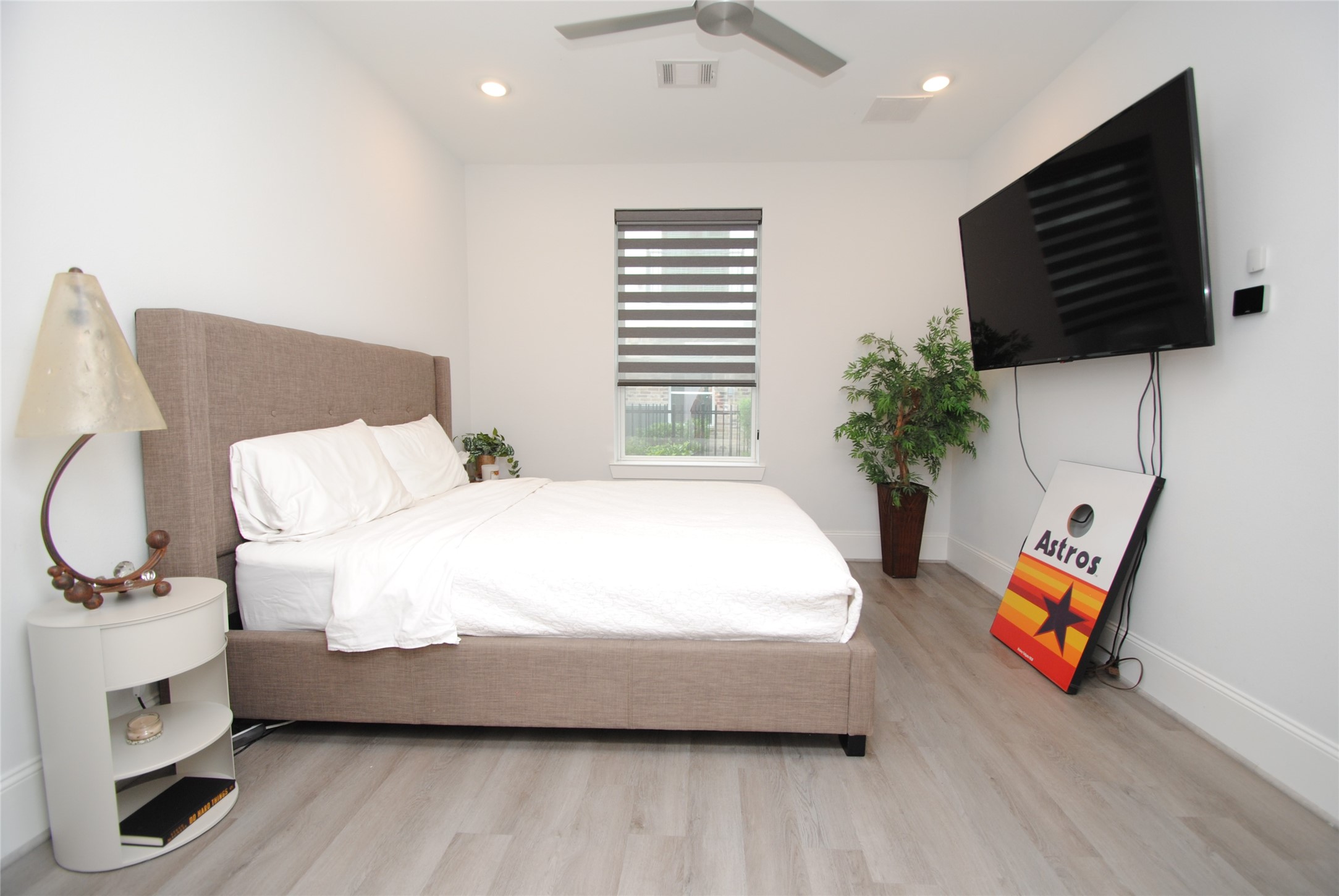 1262 North Post Oak Road, Unit B Houston, TX 77055 - Photo 6 of 44 a bed room with a bed window and a television