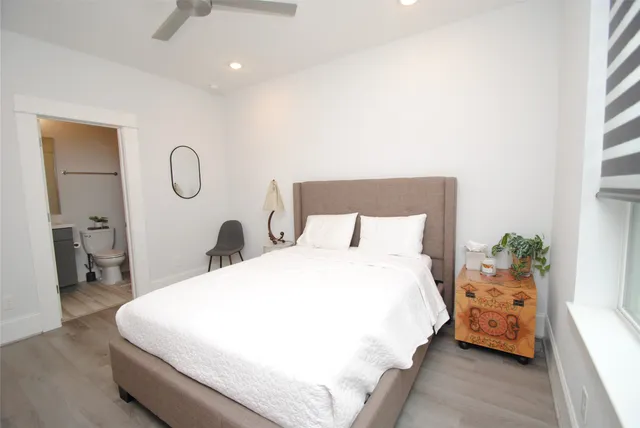 a bedroom with a bed and a chandelier