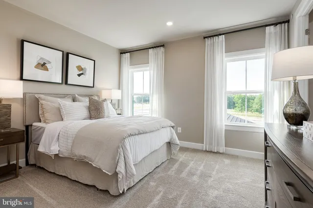 a spacious bedroom with a bed and a window