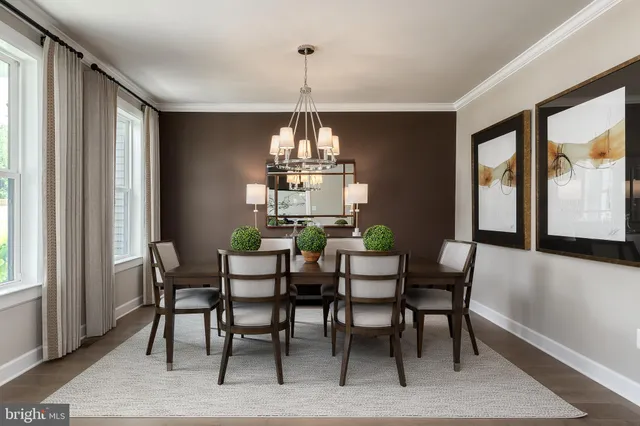 a dining room with furniture a chandelier and wooden floor
