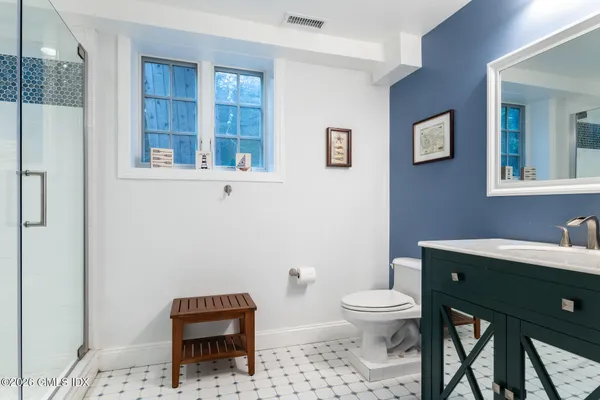 a bathroom with a toilet a sink and a mirror