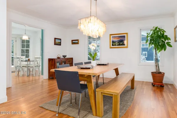 a view of a dining room with furniture window and wooden floor