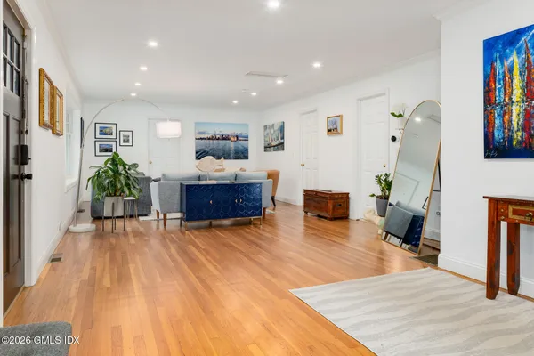 a living room with furniture and a wooden floor