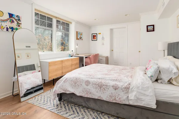 a bed room with a bed and a chair