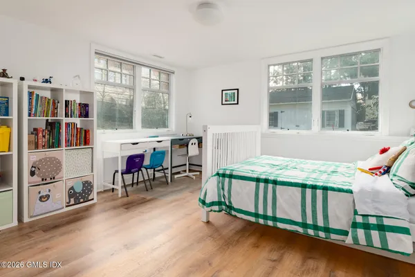 a bedroom with furniture and a window