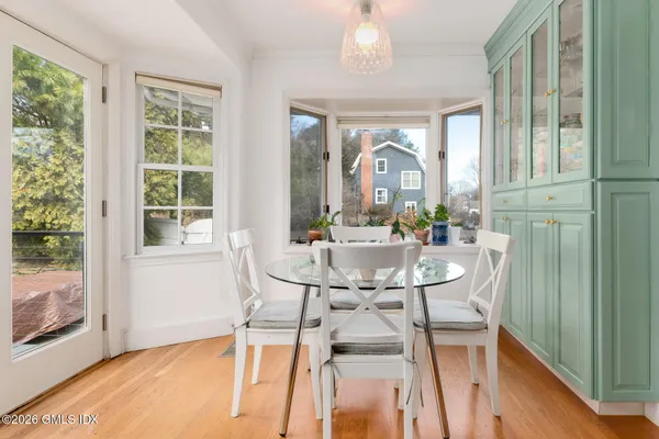 a view of a dining room with furniture and wooden floor