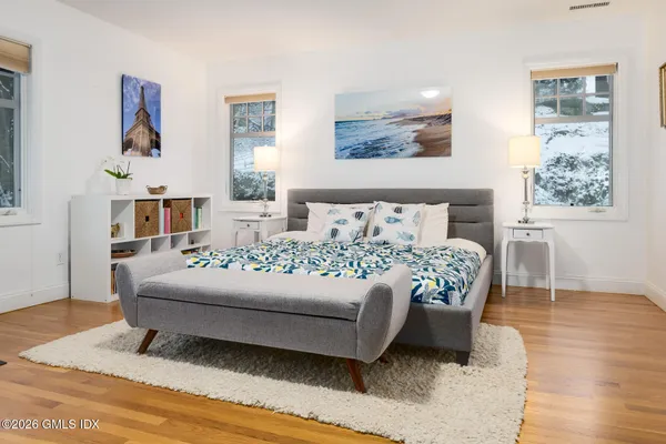 a living room with furniture and painting on the wall