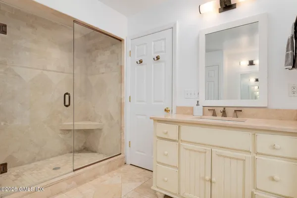a bathroom with a shower sink and mirror