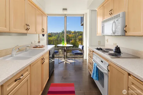 a kitchen with a sink stove and cabinets