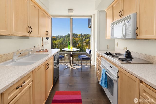 a kitchen with a sink stove and cabinets