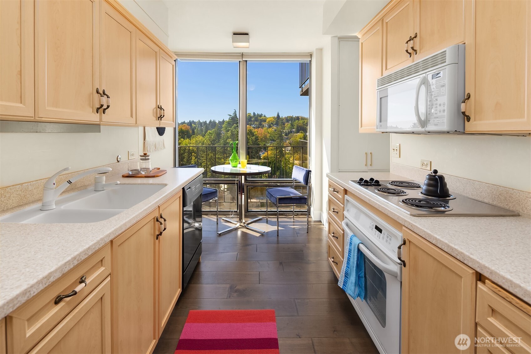 1620 43rd Avenue East, Unit 8C Seattle, WA 98112 - Photo 13 of 27 a kitchen with a sink stove and cabinets