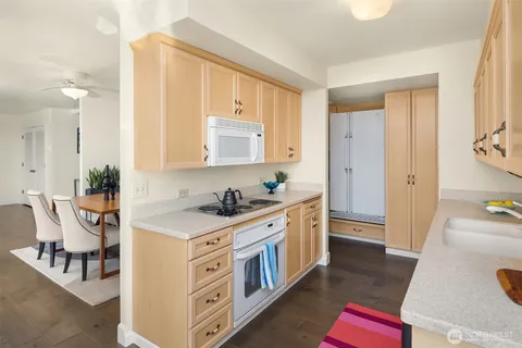 a kitchen with stainless steel appliances a stove a sink and a refrigerator
