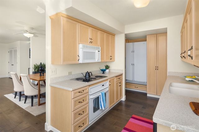 a kitchen with stainless steel appliances a stove a sink and a refrigerator