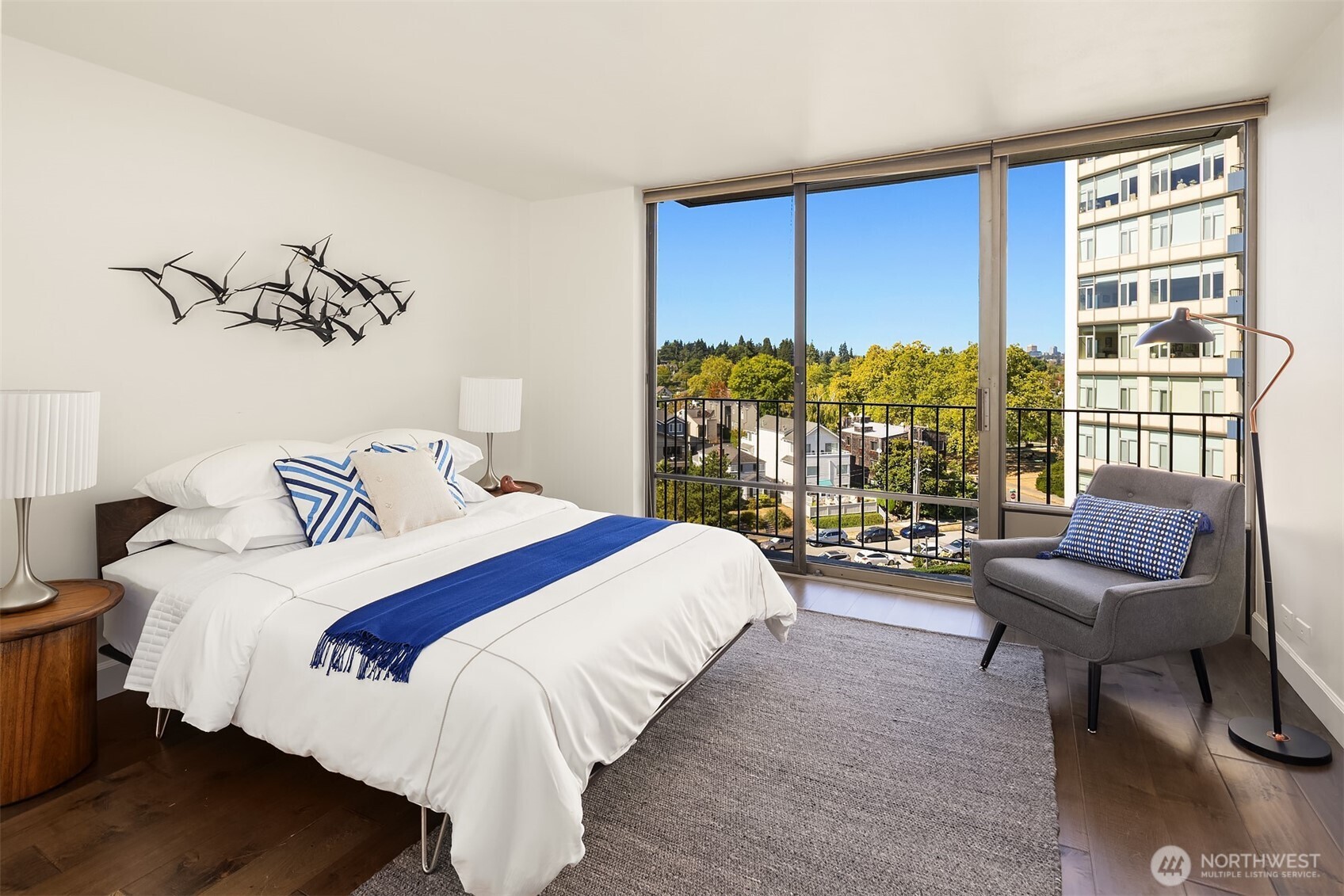 1620 43rd Avenue East, Unit 8C Seattle, WA 98112 - Photo 19 of 27 a bedroom with bed and a large window