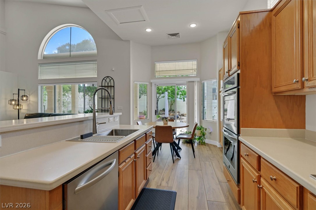 1259 Moon Vision Street Henderson, NV 89052 - Photo 10 of 53 Culinary haven with seamless indoor-outdoor living and integrated dining space.