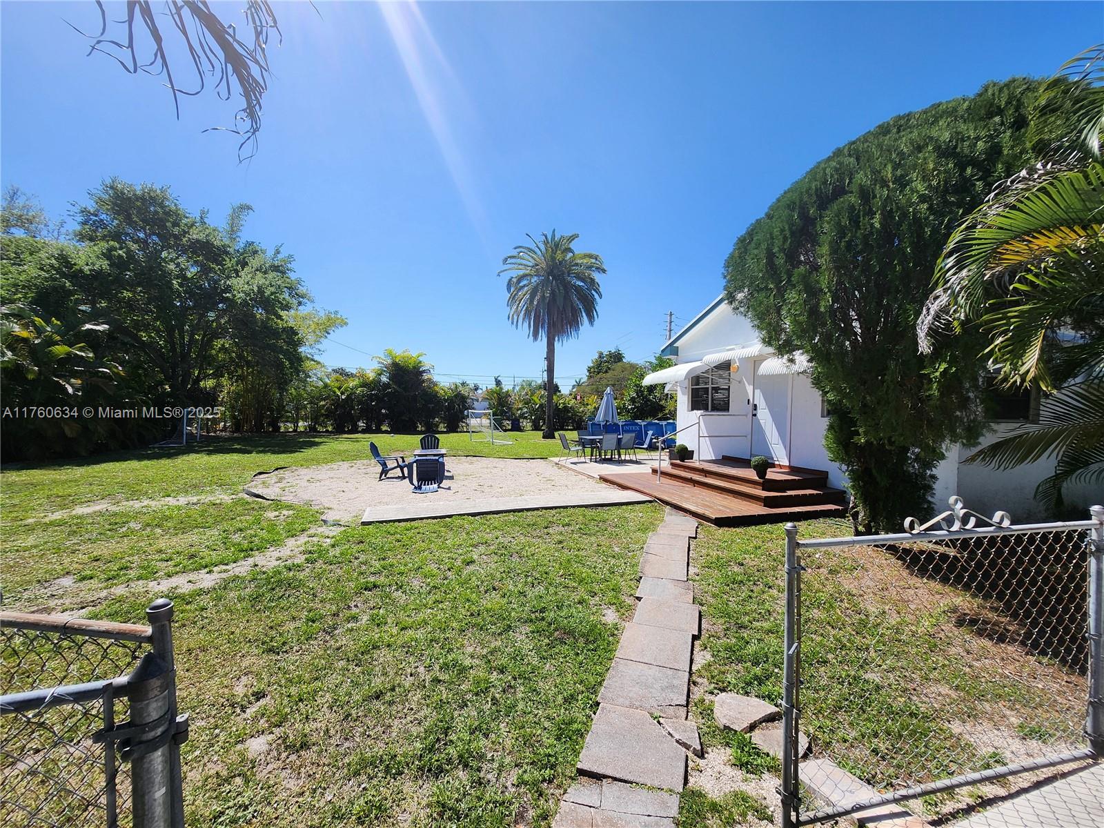 128 Southwest 5th Street Hallandale Beach, FL 33009 - Photo 1 of 17 a view of a swimming pool with a patio and a yard