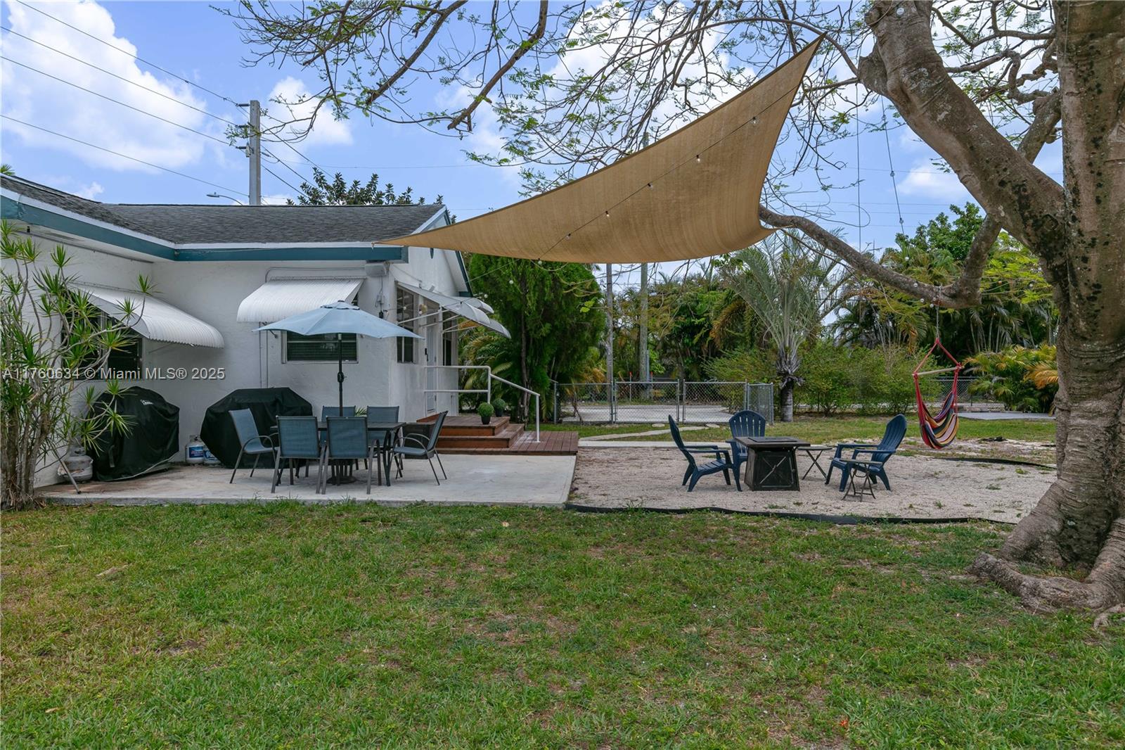 128 Southwest 5th Street Hallandale Beach, FL 33009 - Photo 17 of 17 a view of a chairs and table in patio with a yard