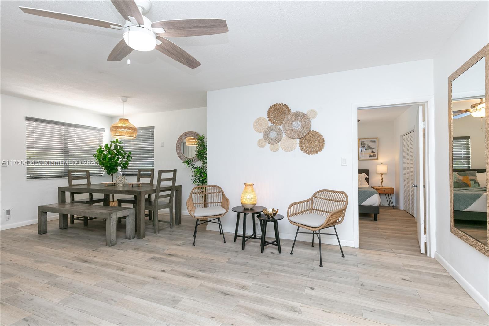 128 Southwest 5th Street Hallandale Beach, FL 33009 - Photo 7 of 17 a view of a dining room with furniture and wooden floor