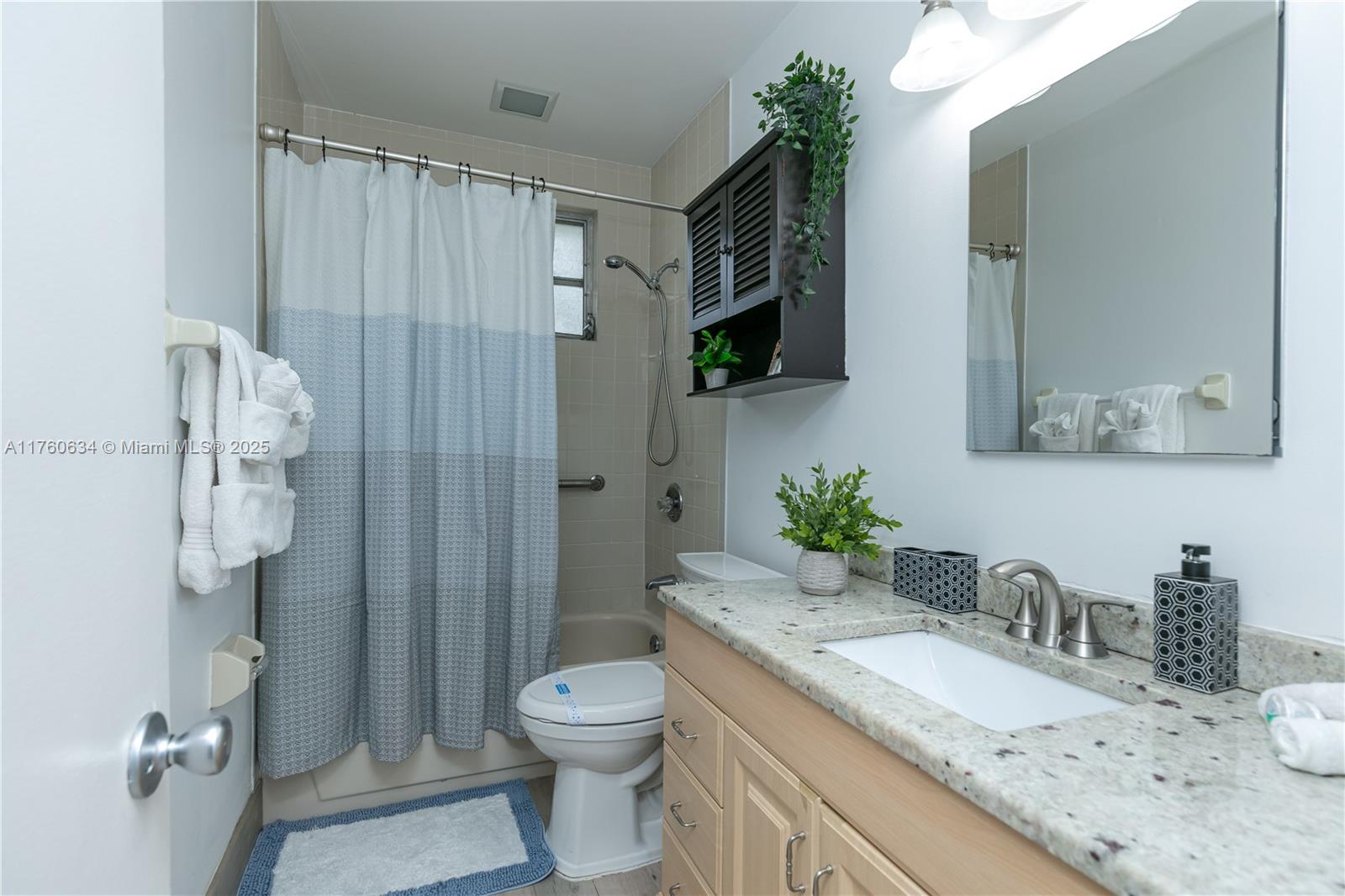 128 Southwest 5th Street Hallandale Beach, FL 33009 - Photo 8 of 17 a bathroom with a granite countertop sink a toilet and shower