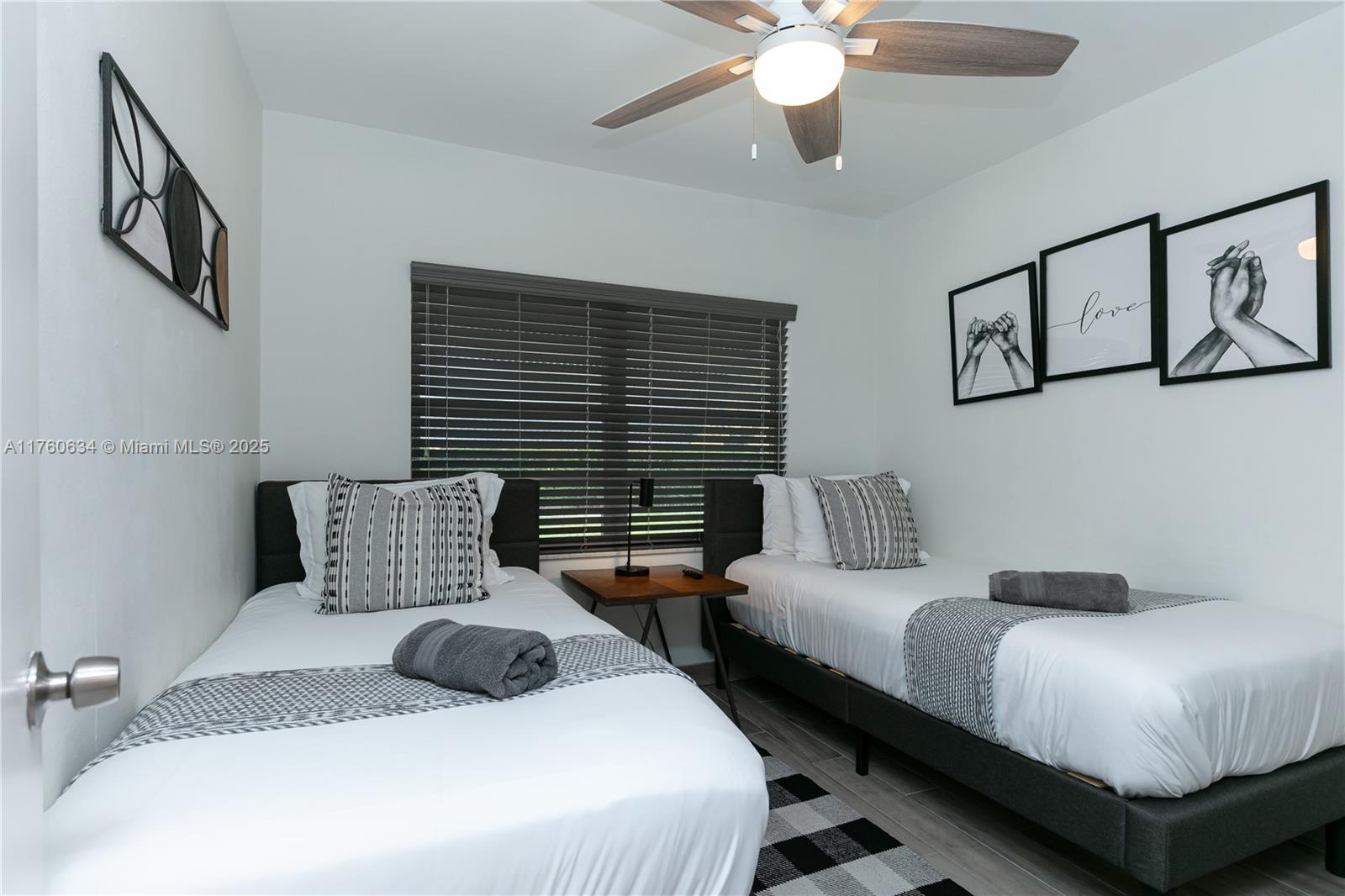 128 Southwest 5th Street Hallandale Beach, FL 33009 - Photo 10 of 17 a bedroom with two beds and ceiling fan