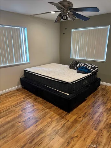 a bed sitting in a bedroom next to a window