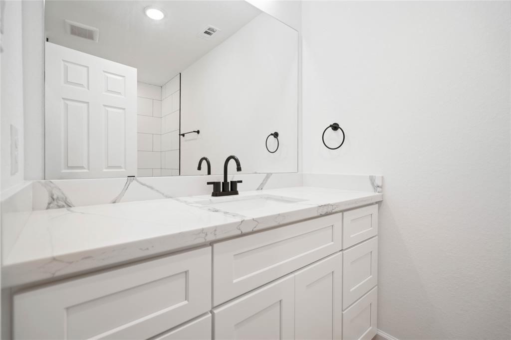 205 Bolden Street, Unit B Houston, TX 77029 - Photo 11 of 15 a bathroom with a sink and a mirror