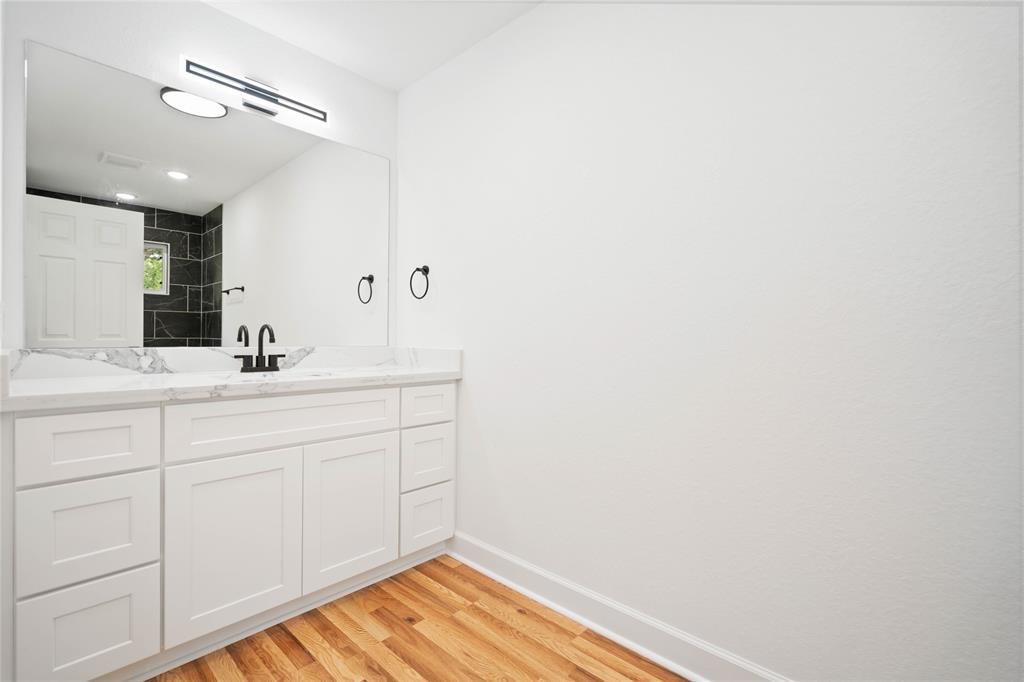205 Bolden Street, Unit B Houston, TX 77029 - Photo 12 of 15 a bathroom with a sink and a mirror