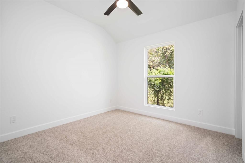 205 Bolden Street, Unit B Houston, TX 77029 - Photo 4 of 15 an empty room with windows and fan