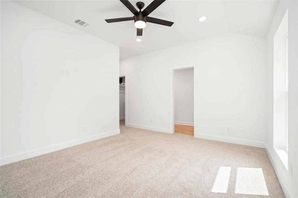 205 Bolden Street, Unit B Houston, TX 77029 - Photo 5 of 15 an empty room with a ceiling fan and carpet