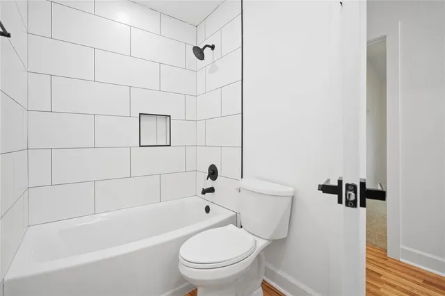 a bathroom with a toilet and a bathtub