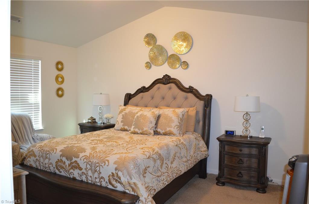 4688 Heatherly Road Winston-Salem, NC 27105 - Photo 11 of 17 Primary bedroom with vaulted ceilings.
