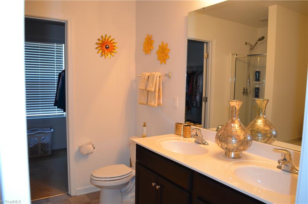 4688 Heatherly Road Winston-Salem, NC 27105 - Photo 13 of 17 Primary bathroom with garden tub, separate shower, and dual sinks.