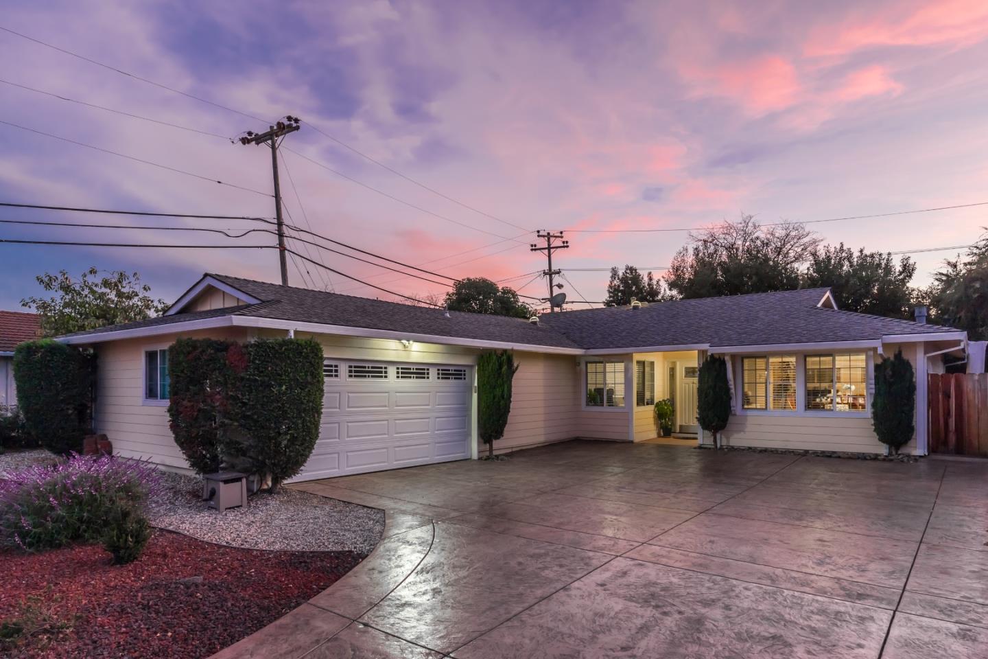 a front view of a house with a garden