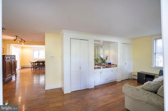 a dining room with furniture and wooden floor