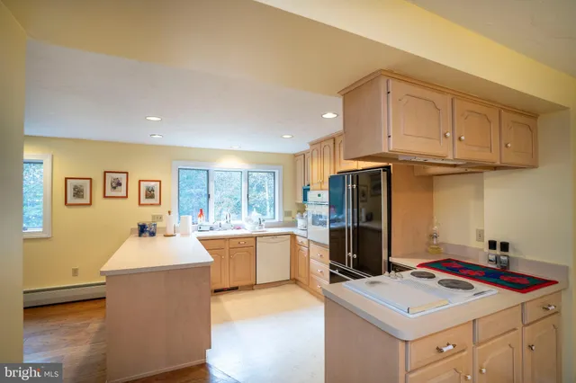 a living room with furniture and a ceiling fan