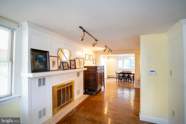 a living room with furniture a fireplace and a table
